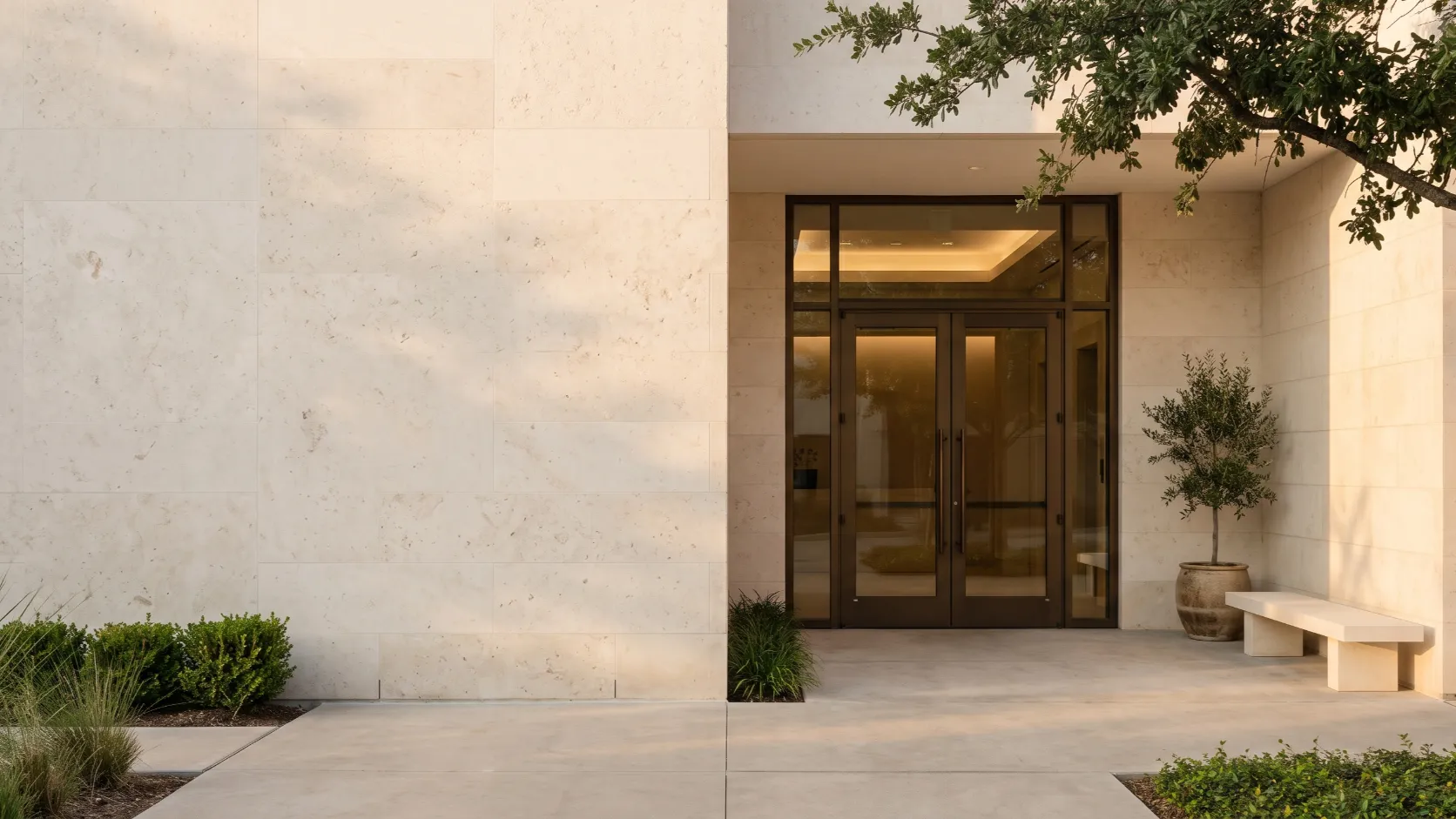 The limestone entrance of a Texas office building at golden hour